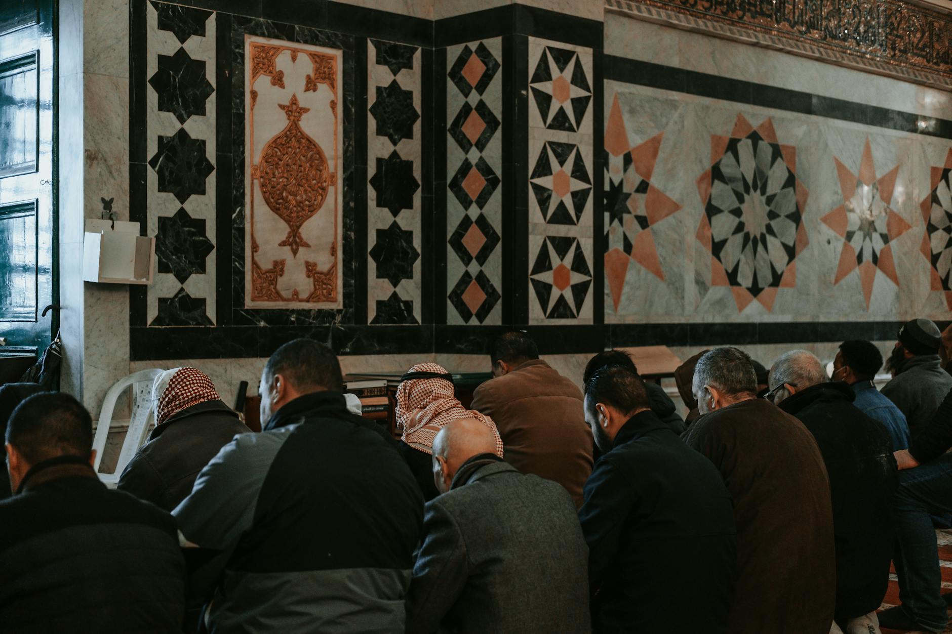 people are praying in a mosque